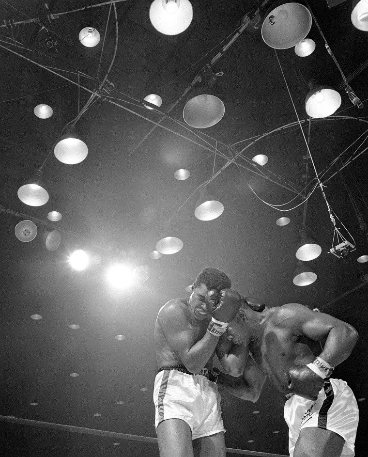 FILE - In this Feb. 25, 1964, file photo, Sonny Liston, right, lowers his head and works in close during the sixth round of heavyweight championship fight against Muhammad Ali (Cassius Clay) in Miami Beach, Fla. Ali turns 70 on Jan. 17, 2012. (AP Photo/File)