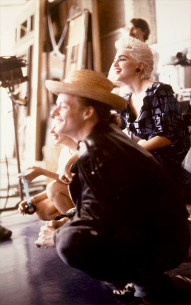 An original color photograph of Madonna and Martin Burgoyne on a film set or at a studio, taken by French photographer Xavier Martin.  Burgoyne was an artist and dancer who collaborated with Madonna on her albums and became a close friend.