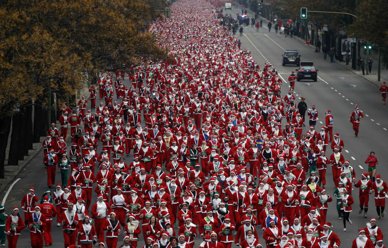 Image: Thousands of runners dressed in Santa outfits compete in the annual Carrera de Papa Noel (Santa Claus Run), in Madrid
