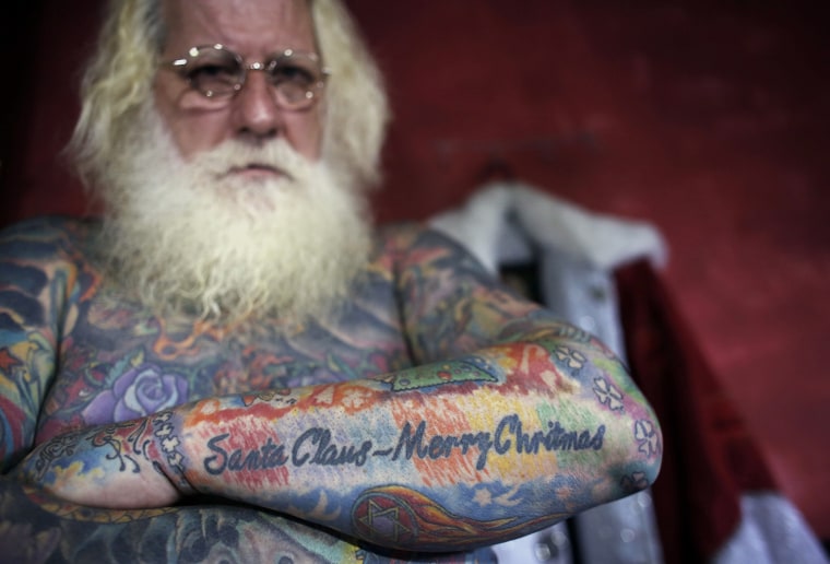 Image: Vitor Martins displays one of his Christmas tattoos inside his house near Sao Paulo