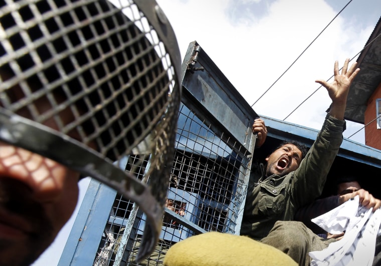 Image: A Kashmiri employee of PHE shouts slogans after being detained by police during a protest in Srinagar
