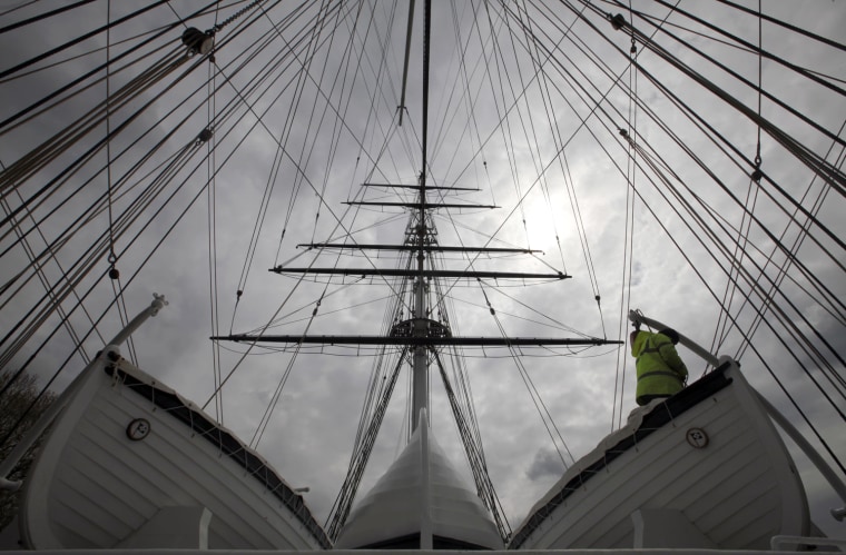Image: Shipwright Kevin Finch works on one of the lifeboats on the clipper Cutty Sark a day before it is due to be officially reopened by Britain's Queen Elizabeth, in Greenwich, South East London