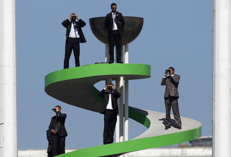 Image: Security guards use binoculars to keep watch during the Algeria Cup final soccer match between CR Belcourt and Entente Setif in Algiers