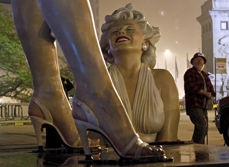 Image: A worker looks at a disassembled 26-foot tall statue of Marilyn Monroe in Chicago
