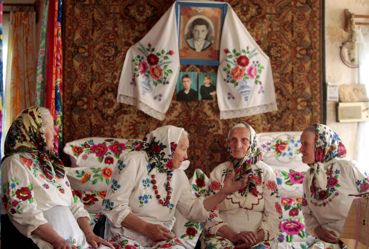 Image: Women in national dresses chat before ritual celebrating pagan god Yurya in Pogost, south of Minsk