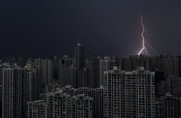 Image: Lightning is seen above buildings during a storm in central Shanghai