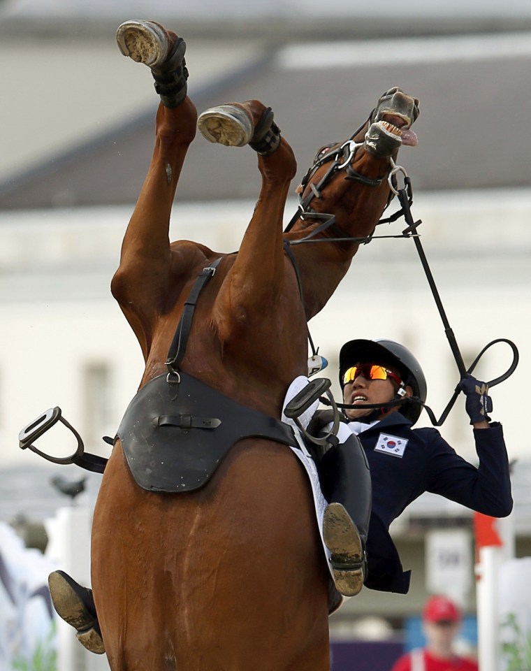 Image: South Korea's Jung Jinhwa riding Foot Perfect falls during the riding event of the men's modern pentathlon during the London 2012 Olympics at Greenwich Park