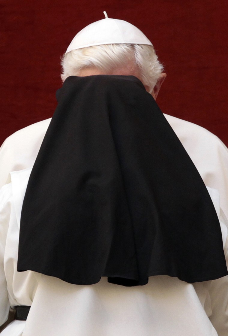 Image: Pope Benedict XVI is obscured by a greeting nun