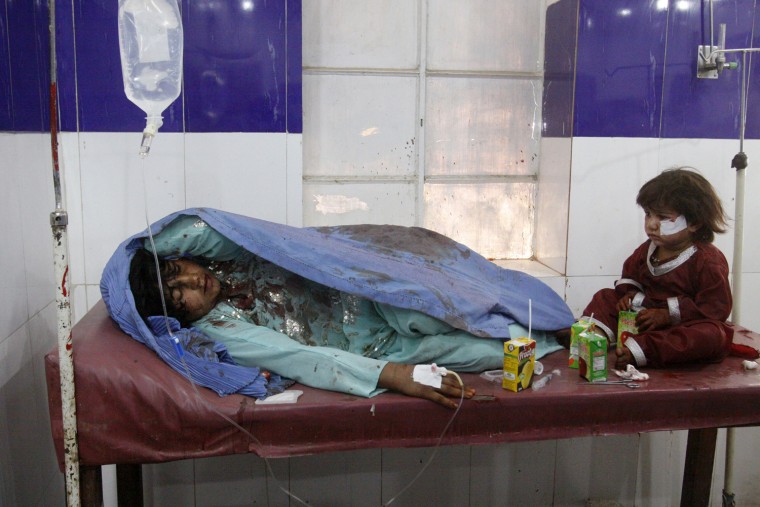 Image: An injured mother and child are treated at  hospital in Pakistan