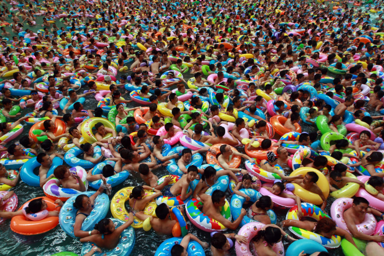 Image: Swimmers wait for the gush of a man-made tide
