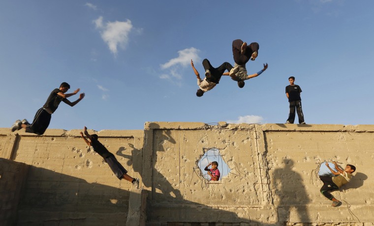 Image: Palestinian youths practice their parkour skills in Khan Younis in the southern Gaza Strip