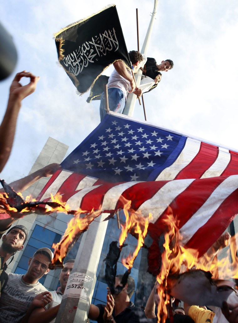 Image: Tunisian protesters burn the U.S. flag during a demonstration outside the U.S. embassy in Tunis
