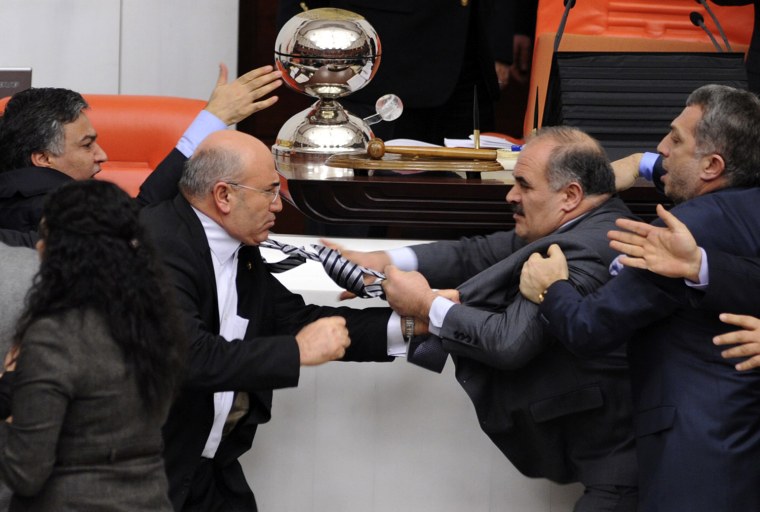 Image: Turkey's ruling AK Party lawmaker Muhittin Aksak and main opposition Republican People's Party lawmaker Mahmut Tanal scuffle during a debate at the parliament in Ankara