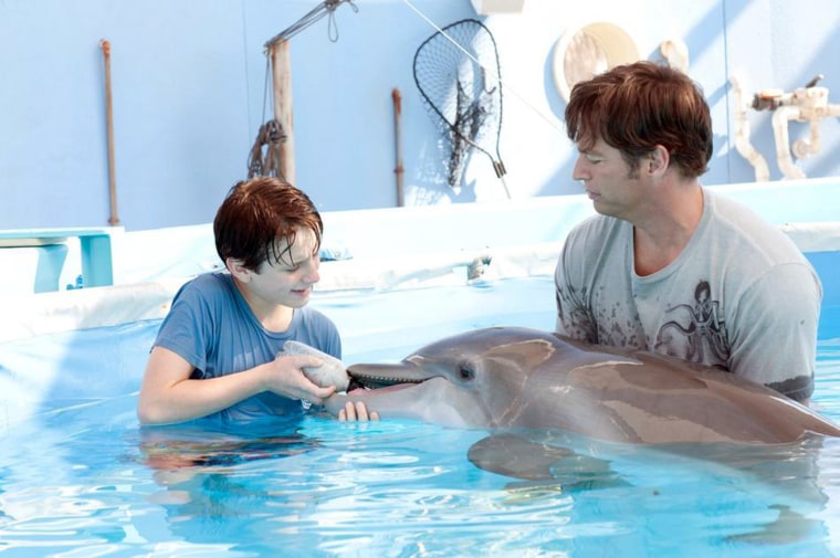 L-r: NATHAN GAMBLE as Sawyer Nelson and HARRY CONNICK, JR. as Dr. Clay Haskett with WINTER in Alcon Entertainment's family adventure 'DOLPHIN TALE,' a Warner Bros. Pictures release. Photo by Jon Farmer.
