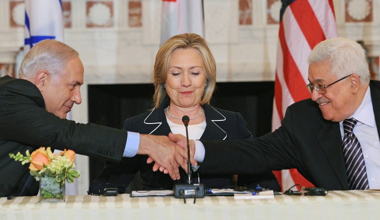 Image: US Secretary of State Hillary Clinton (C), looks on as Prime Minister Benjamin Netanyahu of Israel (L) and President Mahmoud Abbas of the Palestinian Authority (R) shakes hands as they re-launch of direct negotiations between Israeli and Palestinia