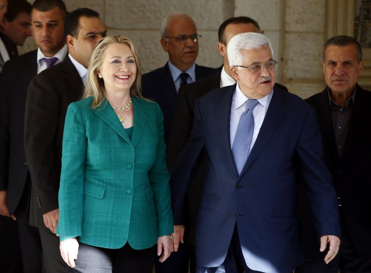 Image: US Secretary of State Clinton walks with Palestinian President Abbas after their meeting in the West Bank city of Ramallah