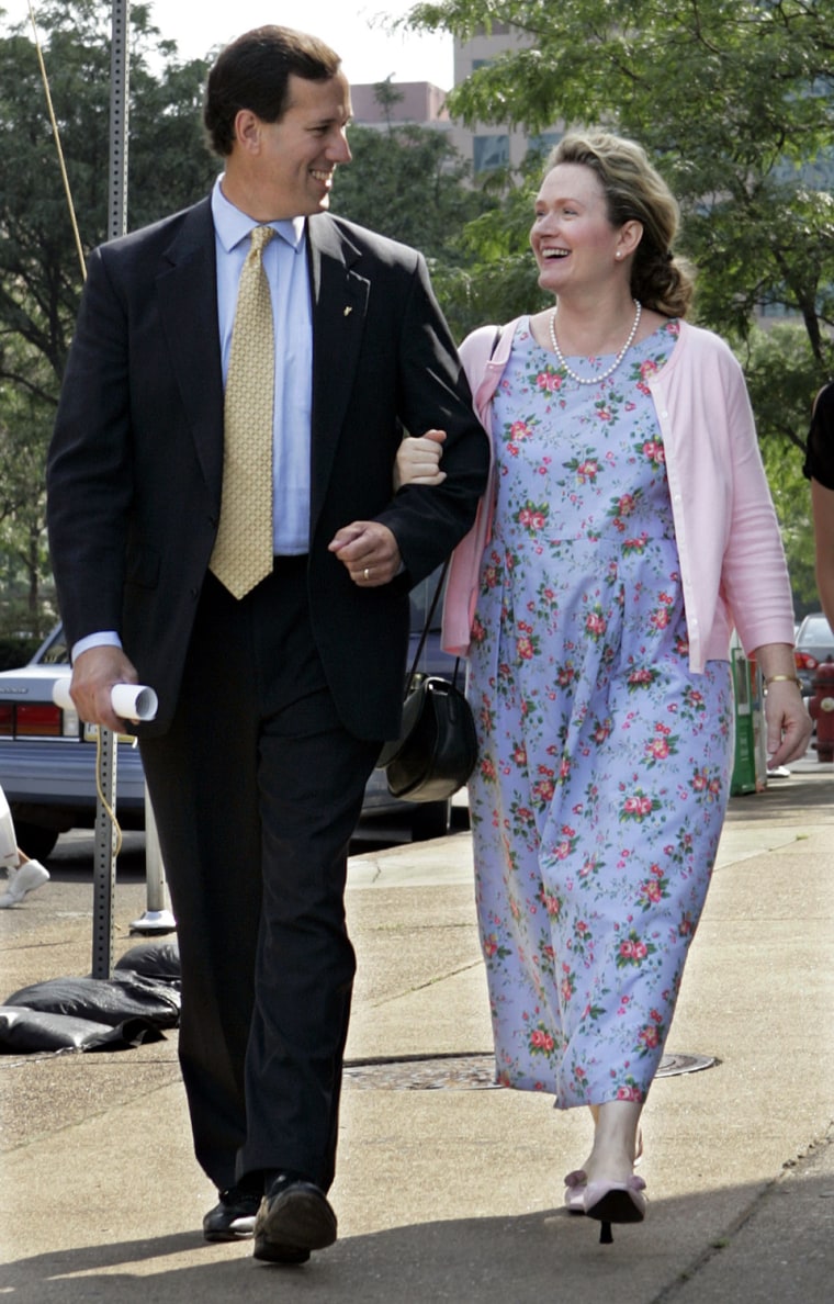 Sen. Rick Santorum, R-Pa., left, walks with his wife, Karen, to a news conference in downtown Pittsburgh on Monday, July 11, 2005. A hearing officer has sided with U.S. Sen. Rick Santorum in a dispute over whether a Pennsylvania school district can get back tax money it paid for Santorum's children to attend an Internet-based charter school while living in Virginia. (AP Photo/Keith Srakocic)