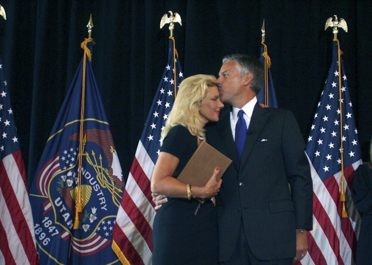 Gov. Jon Huntsman (right) kisses his wife, Mary Kay Huntsman, after signing his resignation document in the Gold Room at the State Capitol in Salt Lake City on Tuesday, Aug. 11,  2009.   (AP Pool/Michael Brandy, Pool)