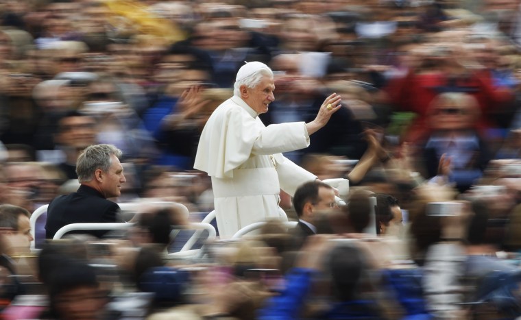 Image: Pope Benedict XVI waves as he arrives to lead his weekly audience in Saint Peter's Square at the Vatican
