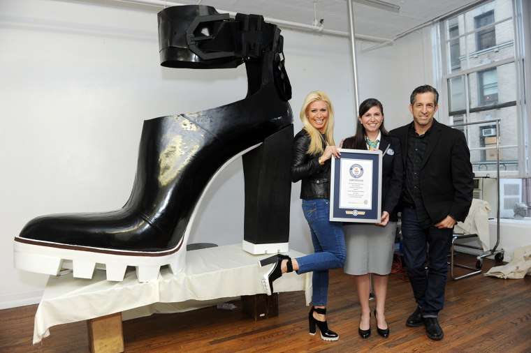 The largest high heeled shoe measures 1.95 m (6 ft 5 in) long and 1.85 m (6 ft 1 in) tall and was created by Jill Martin and Kenneth Cole (both USA) in New York, New York, USA in celebration of Guinness World Records Day 2014.

Online Press Office URL: http://onlinepressoffice.tnrcommunications.co.uk/ tallest-and-shortest-man  
Password:  records                
Site live from:  1700 GMT, Wednesday 12th November 2014
Media Materials available: 0800 GMT, Thursday 13th November 2014
You will be required to enter your name, the name of your organisation, a valid email address and the above password to gain access to the site. Please note that the password is case sensitive.  
All visitors must accept the Terms &amp; Conditions of use governing the site before entering.
Any problems, please contact TNR on  (0)20 7963 7163