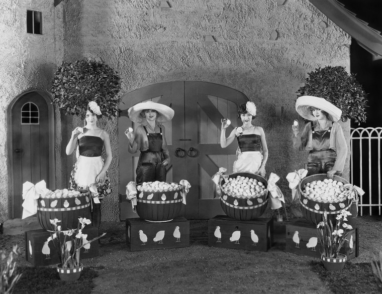 Women posing with huge baskets of eggs