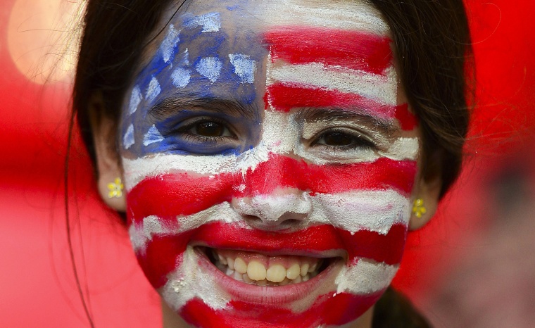 A US supporter has her face painted with