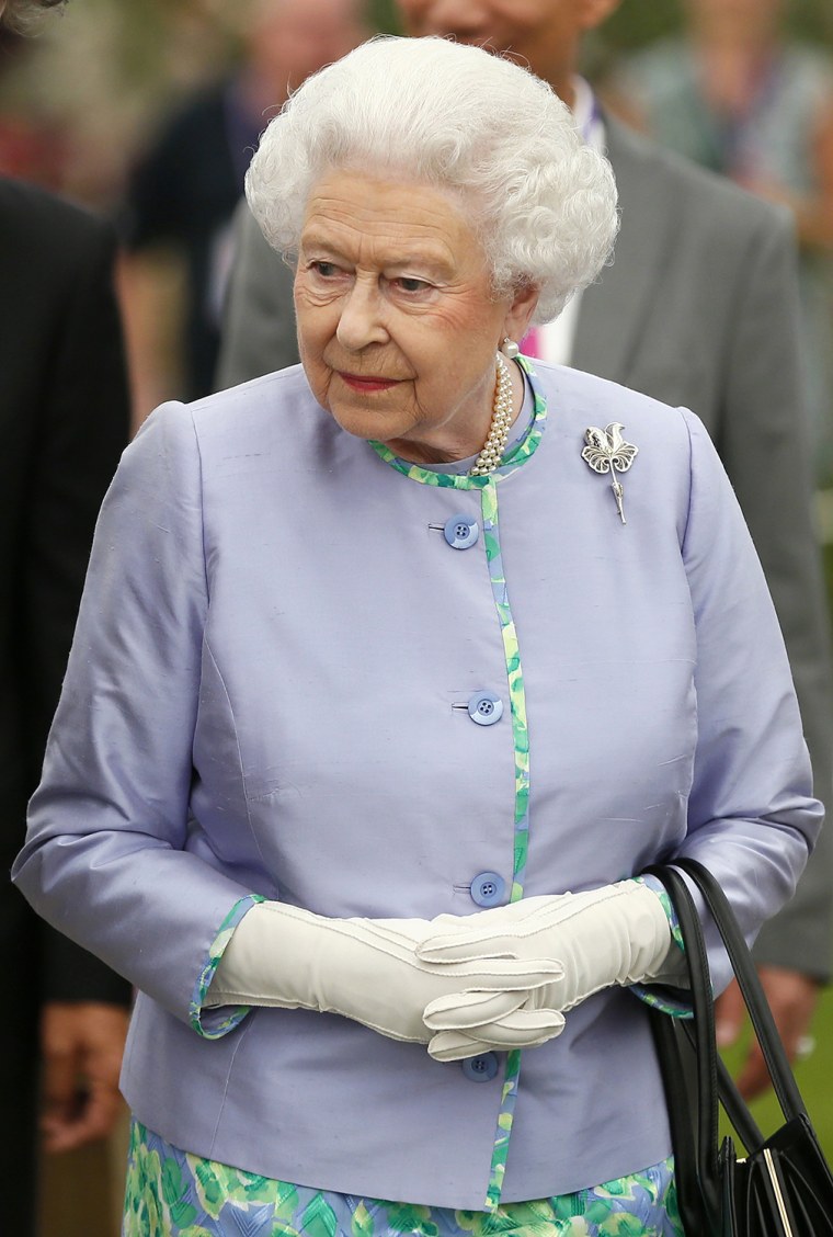 Image: Britain's Queen Elizabeth looks at a display during a visit to the Chelsea Flower Show in London