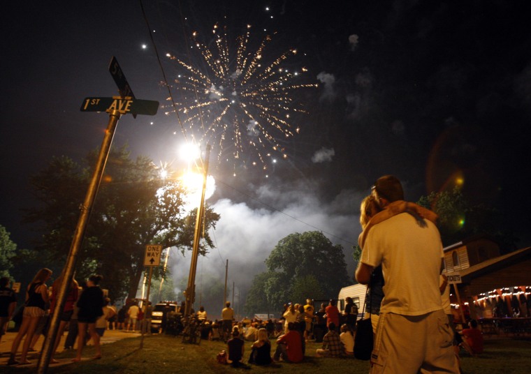 Image: A couple kiss during the Independence Day fireworks display in Independence