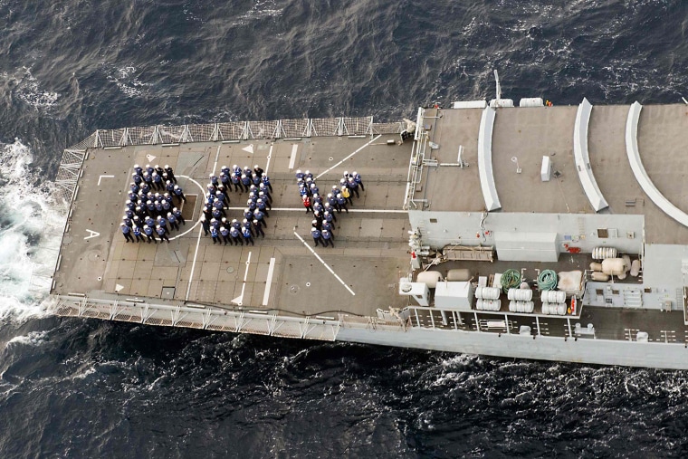 Image: The ship's company of the Royal Navy frigate HMS Lancaster forms the word \"BOY\" on the aft deck to mark the birth of Britain's new prince while on patrol in the Caribbean