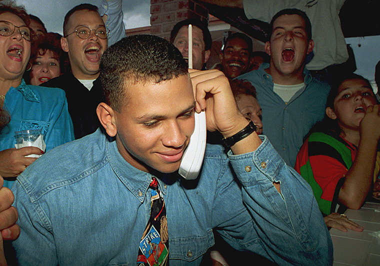 Image: Alex Rodriguez, 18, listens on the telephone as the Seattle Mariners ask him to join their team in 1993.