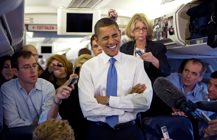 US Democratic presidential hopeful Barack Obama laughs as he talks to the media on his campaign airplane shortly before taking off for Germany about his trip on July 24, 2008, while waiting to take-off in Tel Aviv.   AFP PHOTO/Paul J. Richards (Photo credit should read PAUL J. RICHARDS/AFP/Getty Images)