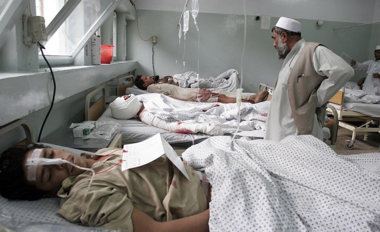 Afghan victims receive treatment at a hospital after they were injured in a suicide attack in Batti Kot district of Nangarhar province, Afghanistan, Thursday, Nov. 13, 2008. A suicide car bomber struck a U.S. military convoy passing through a crowded market in eastern Afghanistan Thursday, killing at least 20 civilians and a U.S. soldier and wounding an additional 74 civilians, officials said. (AP Photo/Rahmat Gul)