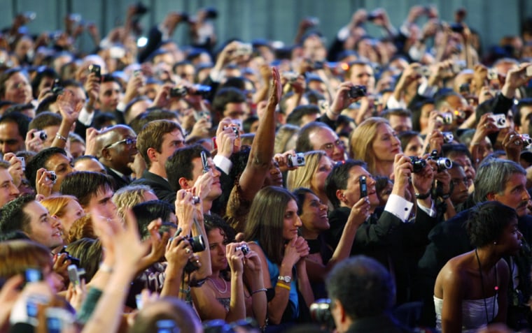 Attendees listen to U.S.  President Barack Obama speak at the leadoff Neighborhood Inaugural Ball in Washington