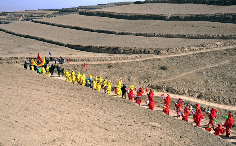 Chinese farmers parade during a ritual for good weather in Gansu province on Feb. 4, the start of spring in the Chinese lunar calendar.