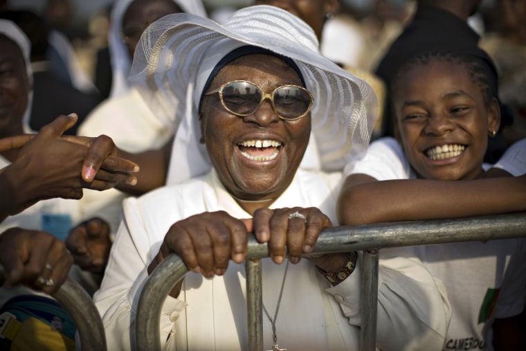 Sister Virginia Amena grins moments after Pope Benedict XVI shook her hand and gave her his blessing upon his arrival in Yaounde