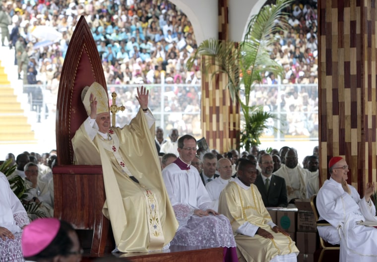 Pope Benedict XVI greets the faithful as he celebrates a Mass in the Amadou Ahidjo stadium, in Yaounde, Cameroon, Thursday, March 19, 2009. The pontiff is in Africa for a seven-day trip that will take him to Cameroon and Angola. (AP Photo/Andrew Medichini)