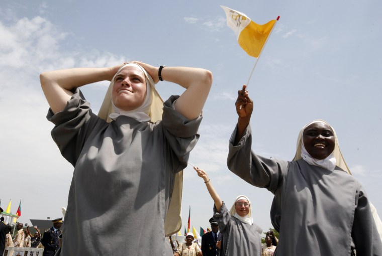 Nuns from the St. John Community in Cameroon react as the plane carrying Pope Benedict XVI takes off, at the airport in Yaounde, Cameroon, Friday, March 20, 2009. Pope Benedict XVI departed for Angola Friday on the second leg of his first papal visit to Africa. (AP Photo/Rebecca Blackwell)