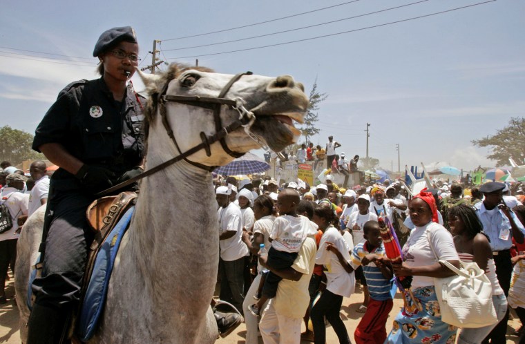 A mounted Angolan soldier controls a crowd of people after Pope Benedict XVI gave Mass in the city of Luanda, Angola, Sunday,  March 22, 2009. Pope Benedict XVI celebrated Mass Sunday with an estimated 1 million Angolans and decried the \"clouds of evil\" over Africa that have spawned war, tribalism and ethnic rivalry that reduce poor people to slavery. (AP Photo/Schalk van Zuydam)