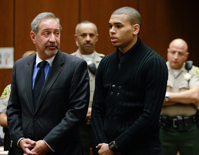 Entertainer Brown stands next to his attorney Geragos as he appears for his arraignment on two felony charges in Los Angeles Superior Court