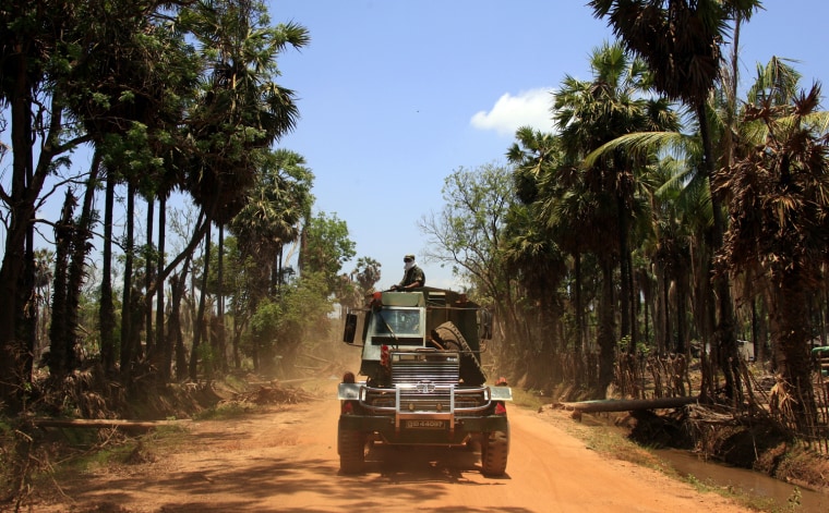 A Sri Lankan government soldier rides in an armoured personal carrier on the outskirts of the town of Putumatalan located near the 'No Fire Zone' in northern Sri Lanka