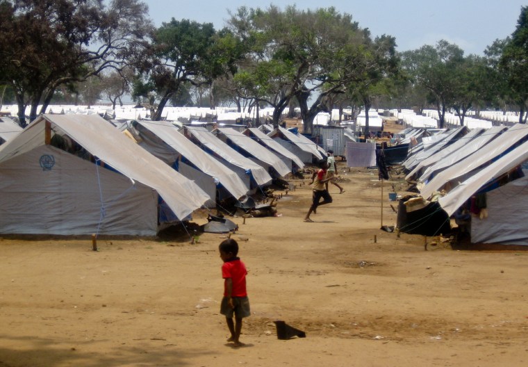 In this photo released by World Vision on Thursday, April 23, 2009 in New York, children are seen outside tents at a displacement camp in Vavuniya, Sri Lanka, on Tuesday, April 21, 2009. Some 170,000 to 180,000 civilians pouring out of Sri Lanka's war zone now live in government camps, a U.N. spokesman in Colombo said Thursday, April 23, 2009. (AP Photo/World Vision, Asanga Warnakulasuriya) ** NO SALES, EDITORIAL USE ONLY, MANDATORY CREDIT **
