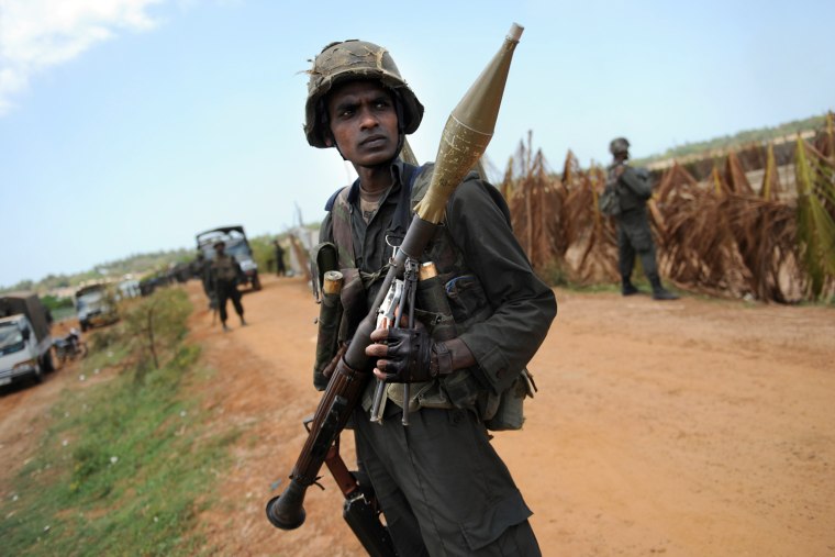 Image: Sri Lankan soldiers stand guard near Puthukkudiyiruppu