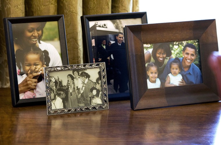 Personal photographs sit behind the desk of U.S. President Barack Obama at the White House in Washington