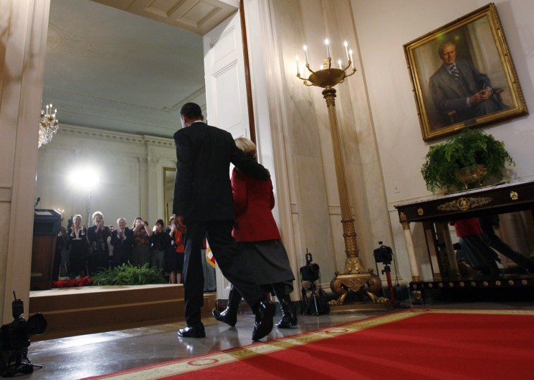 U.S. President Obama walks to East Room with Lilly Ledbetter in Washington