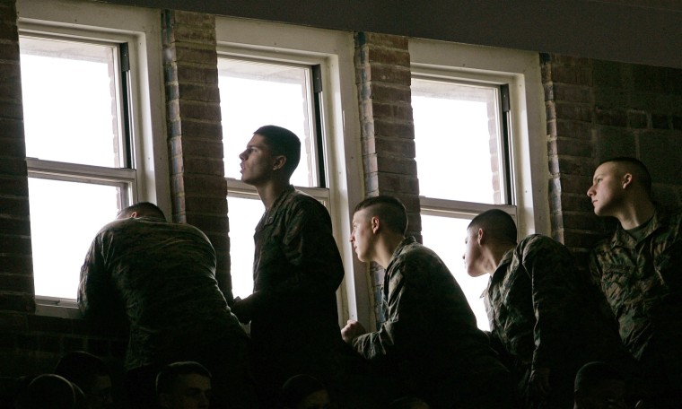 Marines peer though a window awaiting the arrival of President Barack Obama at Camp Lejeune, N.C., Friday, Feb. 27, 2009. (AP Photo/Gerry Broome)