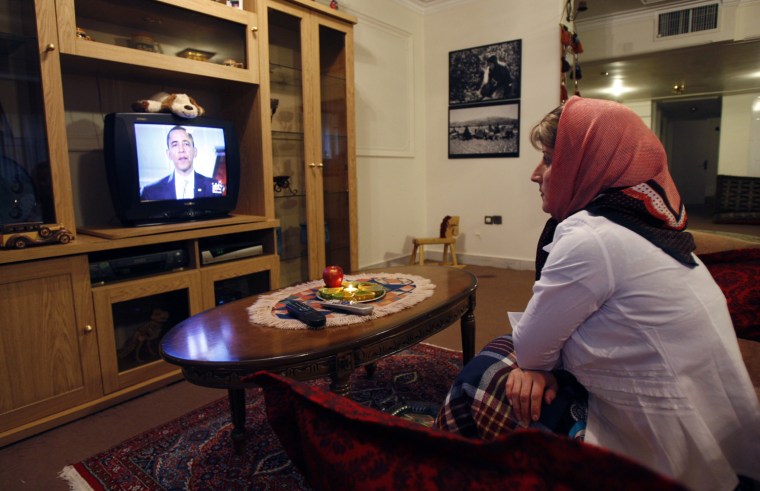 Iranian woman Marzieh Masaebi watches a TV video showing US President Barack Obama's new video message addressed to the Iranian people, and broadcast from the Tapesh Farsi-language satellite TV beamed in from the United States, at her home in Tehran, Iran, Friday, March 20, 2009.  Obama released the video to coincide with the major Iranian festival of Nowruz, a 12-day holiday that marks the arrival of spring and the beginning of the new year in Iran.  Iran authorities played down Obama's video message saying it welcomed the overtures while warning that decades of mistrust can't easily be erased. (AP Photo/Vahid Salemi)