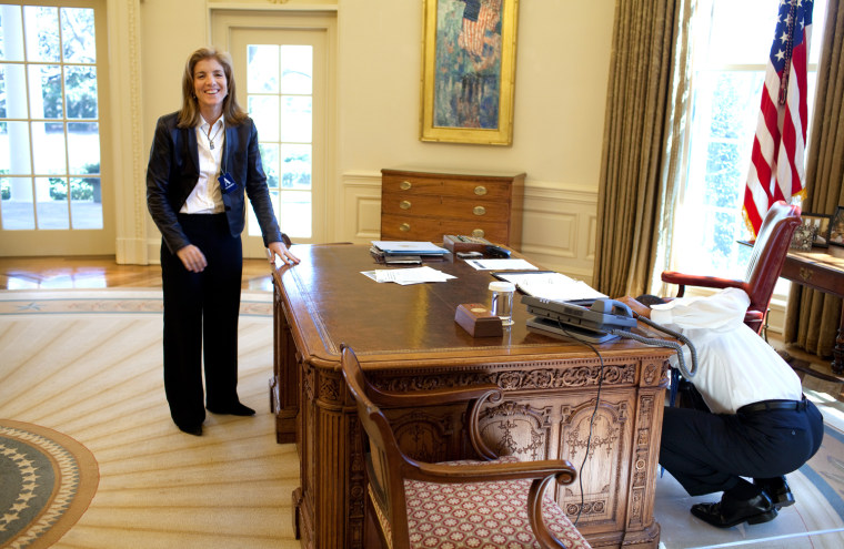 President Barack Obama examines  the Resolute Desk on March 3, 2009, while visiting with Caroline Kennedy Schlossberg in the Oval Office. In a famous photograph, her brother John F. Kennedy Jr., peeked through the FDR panel, while his father President Kennedy worked. 
Official White House Photo by Pete Souza