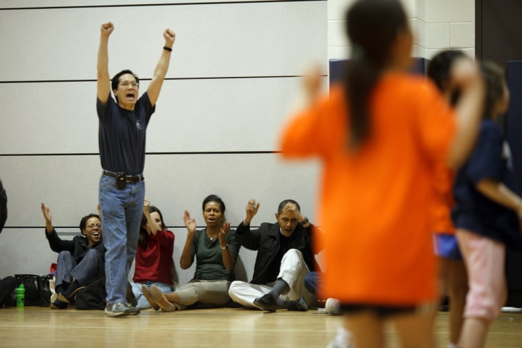 President Barack Obama and First Lady Michelle Obama cheer during their daughter Sasha Obama's basketball game.  2/21/09
Official White House Photo by Pete Souza