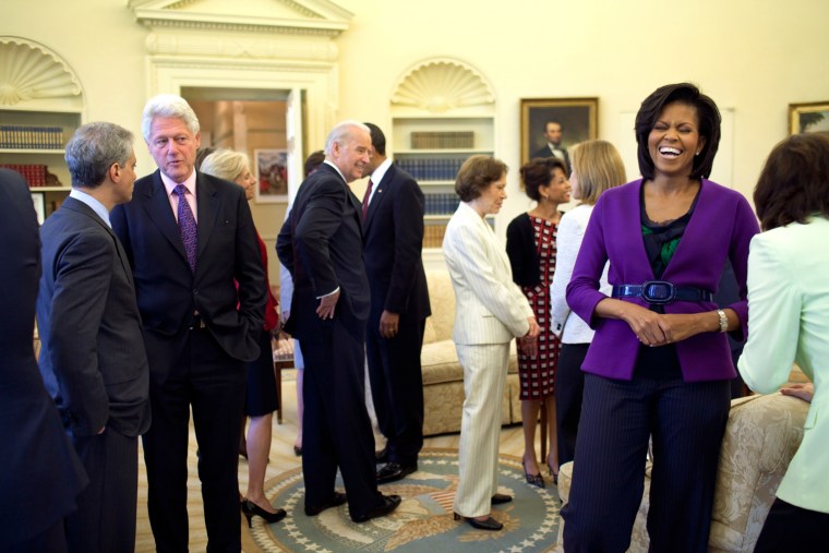 President Barack Obama, background, and First Lady Michelle Obama greet guests in the Oval Office April 21, 2009, including former President Bill Clinton, U.S. Senator Edward M. Kennedy, former first  lady Rosalynn Carter, center, along with Vice President Joe Biden. Official White House Photo by Pete Souza