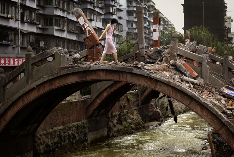 A woman crosses a damaged bridge following May 12 earthquake in Hanwang town in China's southwest Sichuan province Wednesday, May 28, 2008. (AP Photo/Oded Balilty)